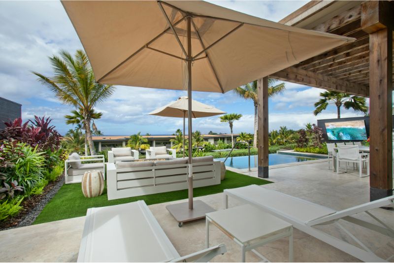 A concrete patio extending to a pool surround