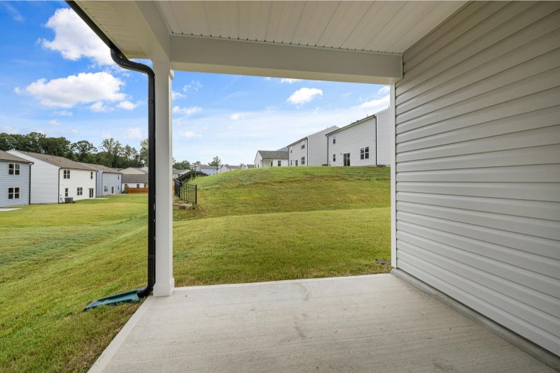 An extension of a concrete patio on a house